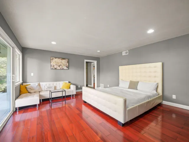 a bedroom with a bed and a couch