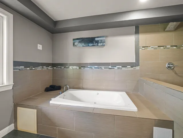 a bathroom with a bathtub and shower