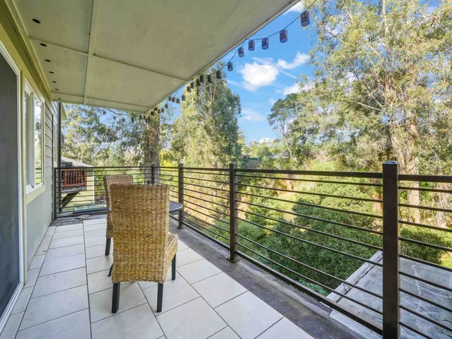 a view of two chairs in the balcony