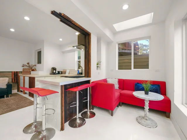 a living room with kitchen island furniture and a chandelier
