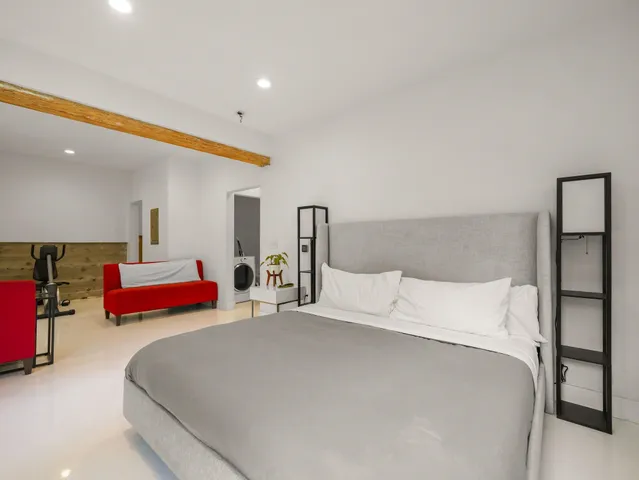 a bedroom with bed and a night stand