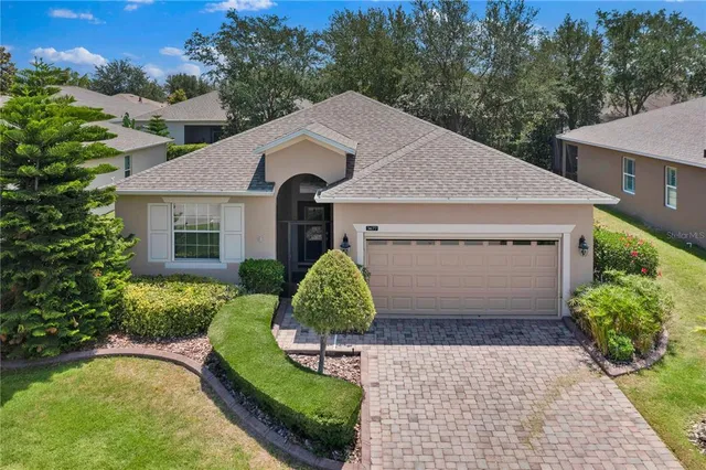 a aerial view of a house with a yard and garage