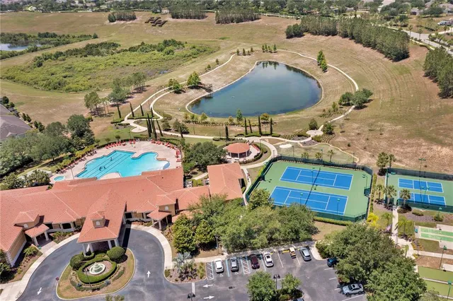 an aerial view of a house with garden space and a car parked