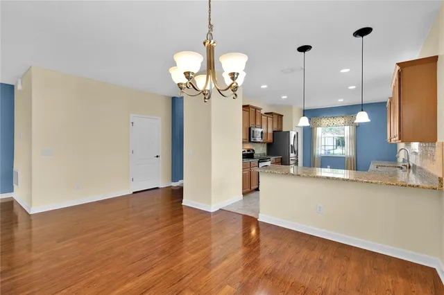 a view of a kitchen with a sink and a chandelier