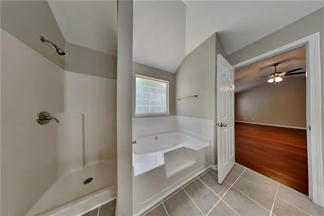 a bathroom with a glass shower door and a bathtub