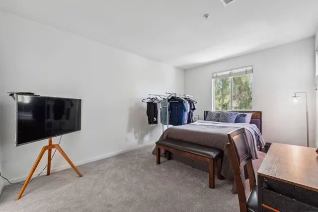 a room with a bed and a flat screen tv