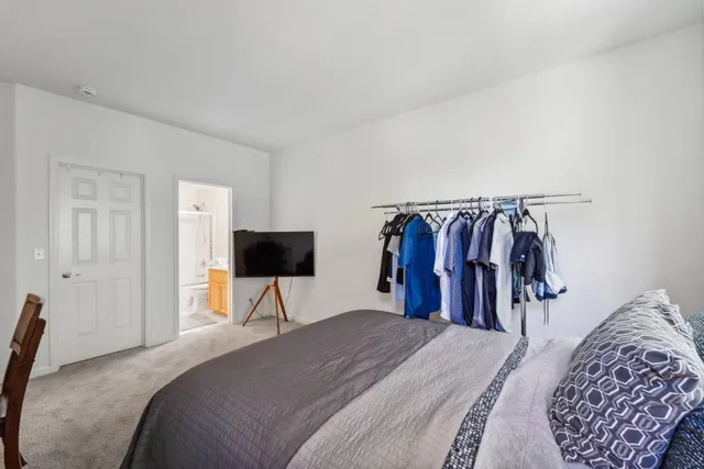 a bedroom with a bed and a mirror