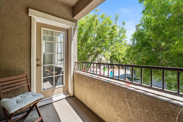 a view of a balcony with wooden floor and fence