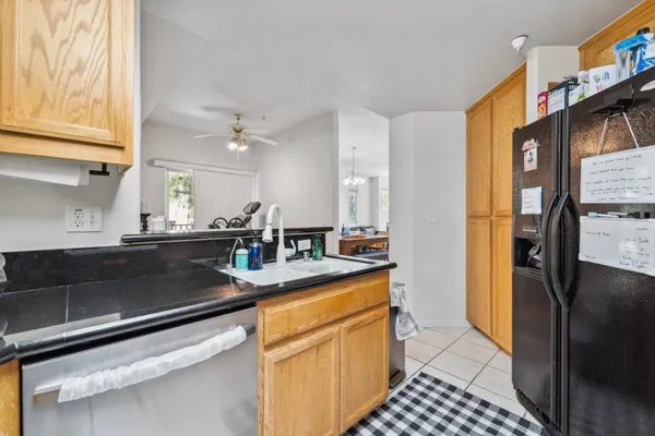 a kitchen with stainless steel appliances a sink a stove refrigerator and cabinets