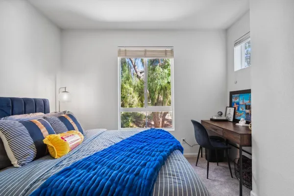 a bedroom with a bed and a desk