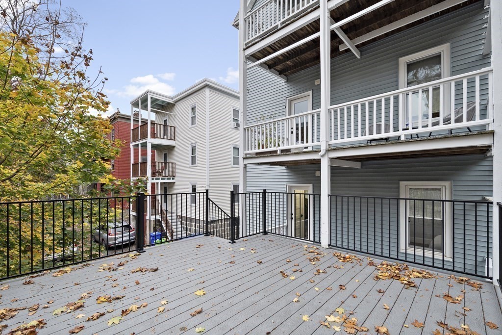 75 Tower Street, Unit 1 Boston, MA 02130 - Photo 13 of 16 a view of a house with a wooden deck