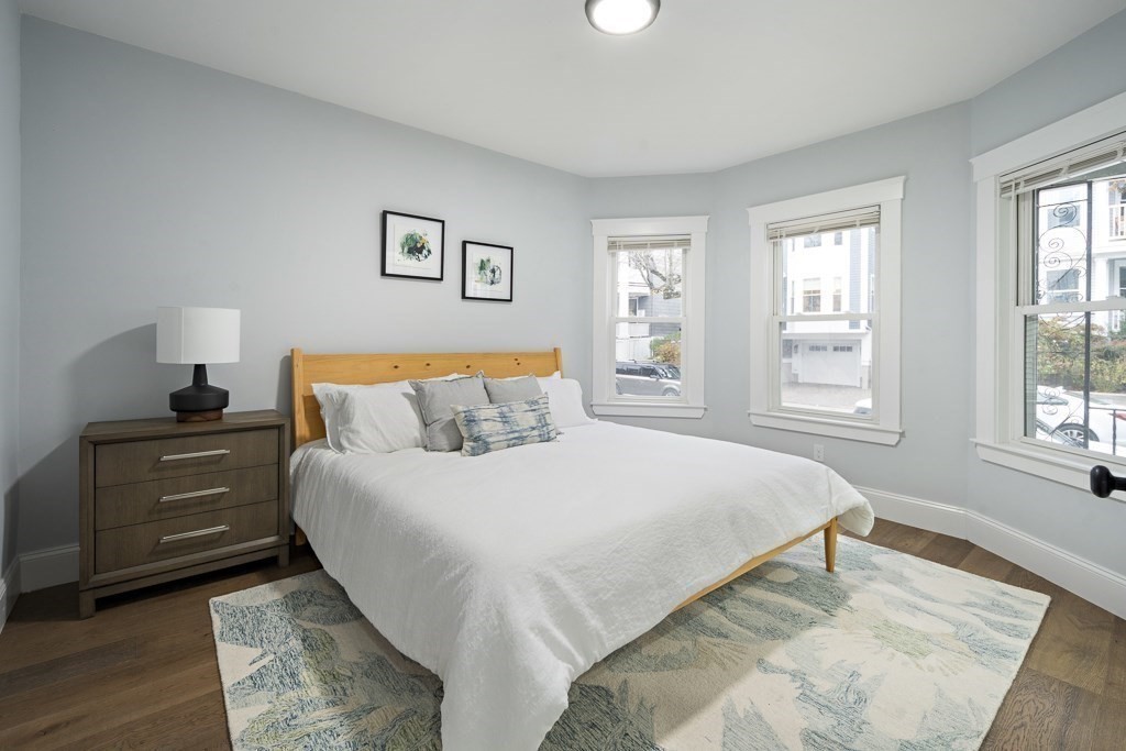 75 Tower Street, Unit 1 Boston, MA 02130 - Photo 6 of 16 a bedroom with a bed and a dresser