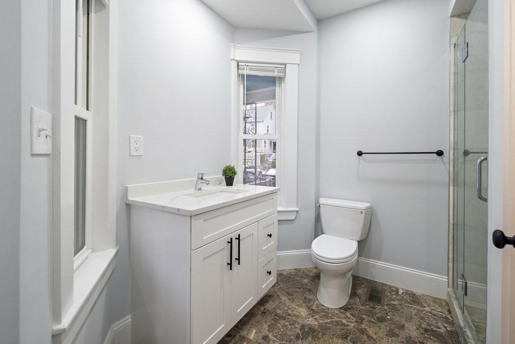 75 Tower Street, Unit 1 Boston, MA 02130 - Photo 7 of 16 a bathroom with a sink toilet and a mirror