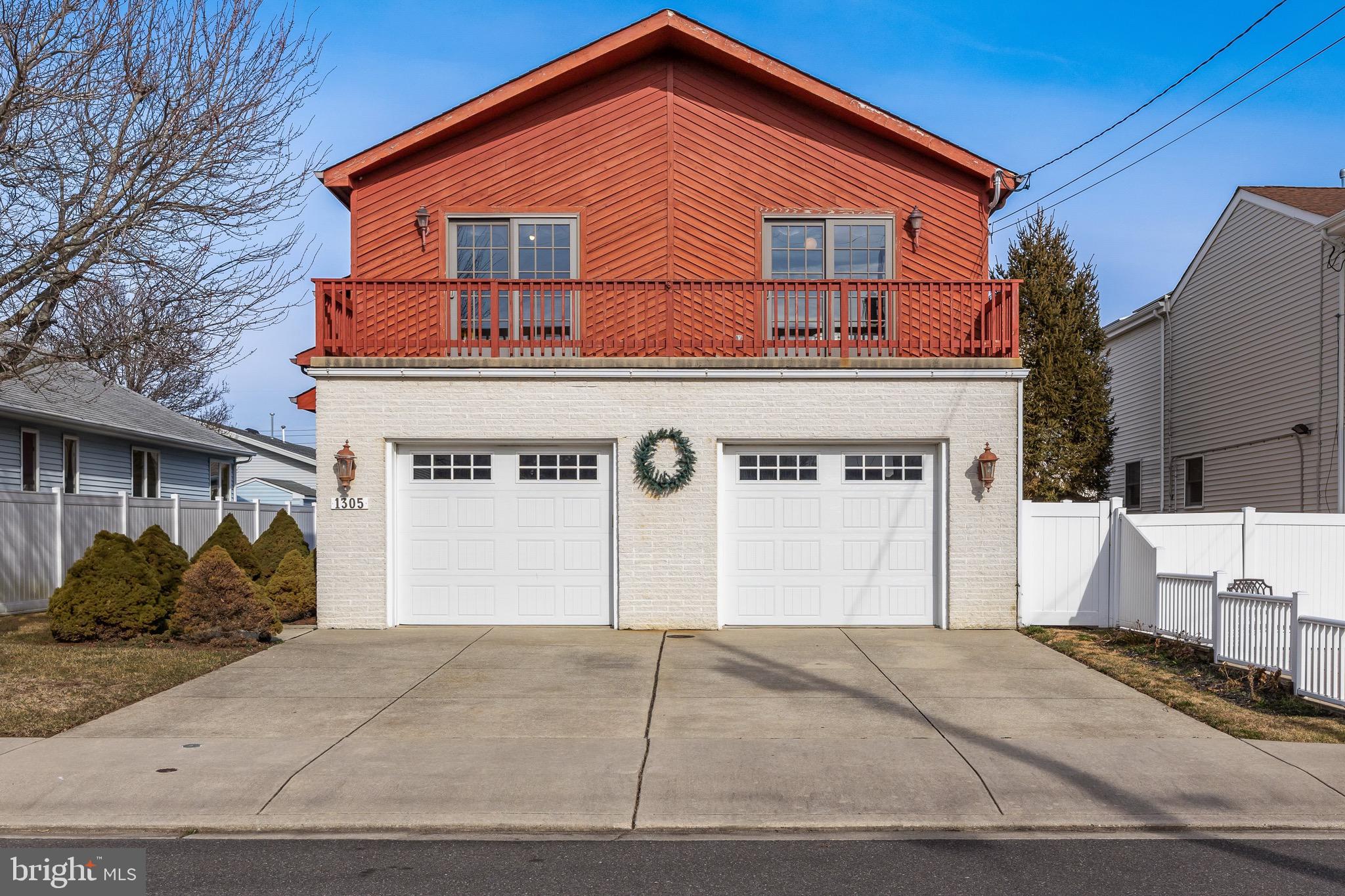 1305 Vardon Road Brigantine, NJ 08203 - Photo 1 of 1 a front view of a house with a yard and garage