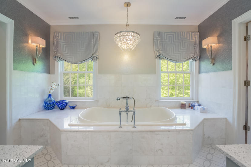 485 June Road Stamford, CT 06903 - Photo 21 of 37 a bathroom with a tub sink and mirror
