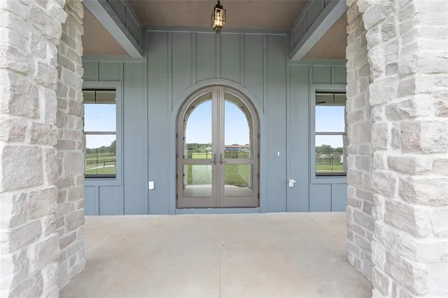 a view of a livingroom with a flat screen tv wooden floor and a ceiling fan