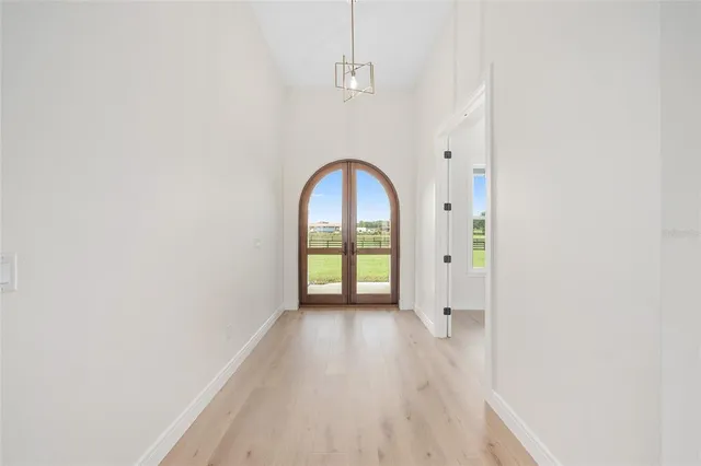 a view of an empty room with a fireplace and a window