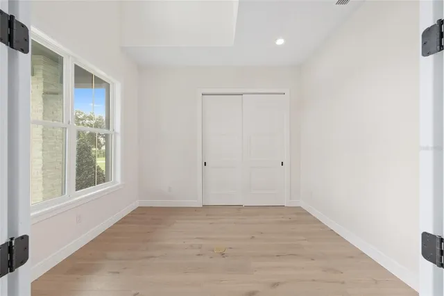 a view of an empty room with a fireplace and a large window