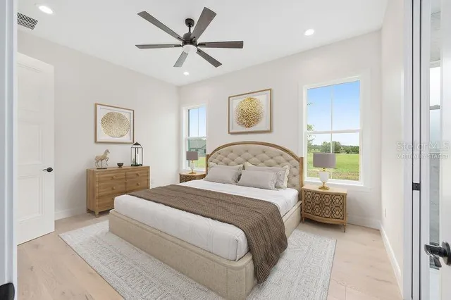 a bedroom with a large bed and a window