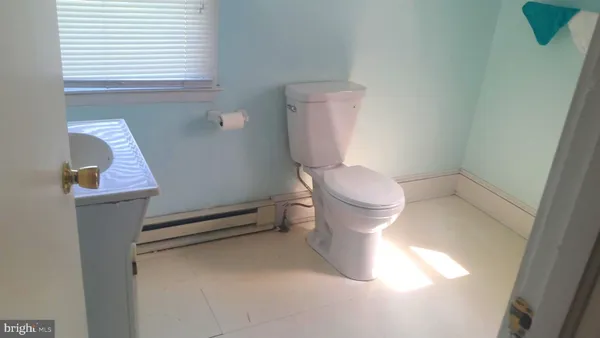 a white toilet sitting next to a bathroom sink