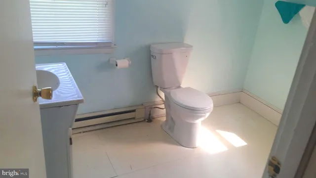 a white toilet sitting next to a bathroom sink