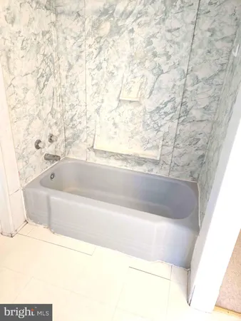 a white bath tub sitting next to a white sink