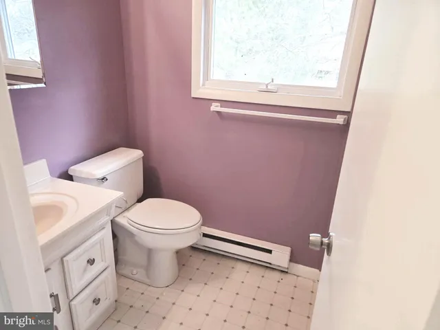 a white toilet sitting next to a bathroom sink