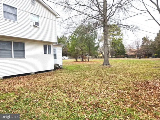 a view of a yard with a house and a tree