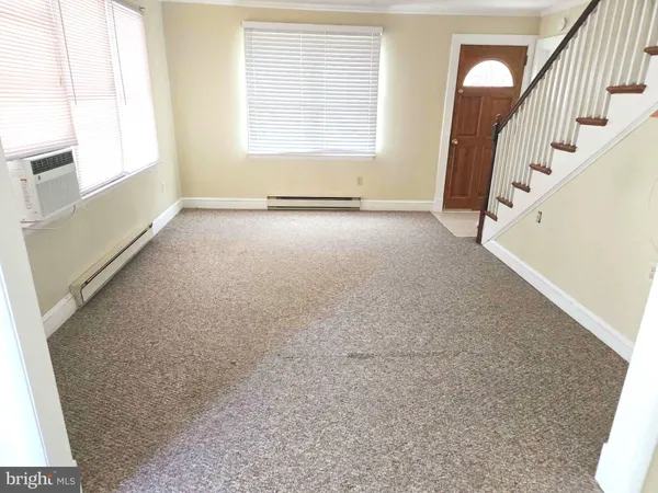 a view of an empty room with stairs