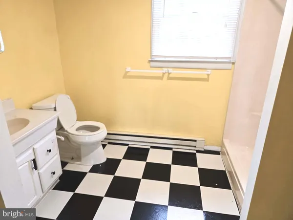 a bathroom with a black and white checkered floor