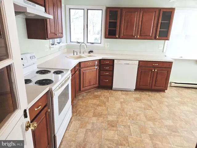 a kitchen with stainless steel appliances a stove a sink and a microwave