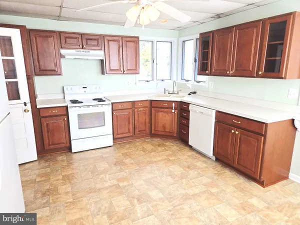 a kitchen with sink a stove and cabinets