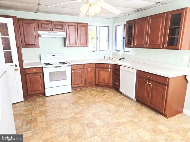a kitchen with sink a stove and cabinets
