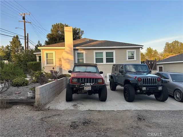 a view of a car parked in front of a house