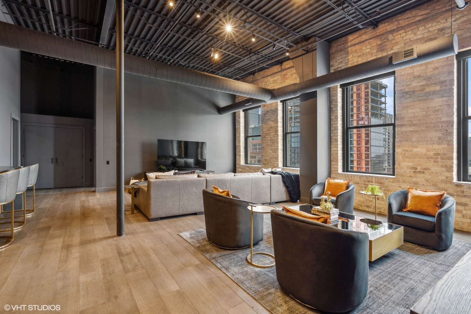 312 North May Street, Unit 6L Chicago, IL 60607 - Photo 8 of 14 a living room with furniture and a flat screen tv