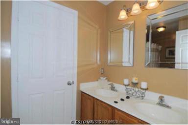 7417 Maury Road Windsor Mill, MD 21244 - Photo 4 of 19 a bathroom with a sink and a mirror