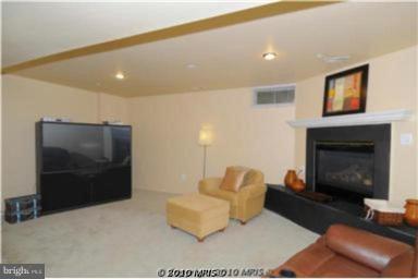 7417 Maury Road Windsor Mill, MD 21244 - Photo 5 of 19 a living room with furniture and a fireplace
