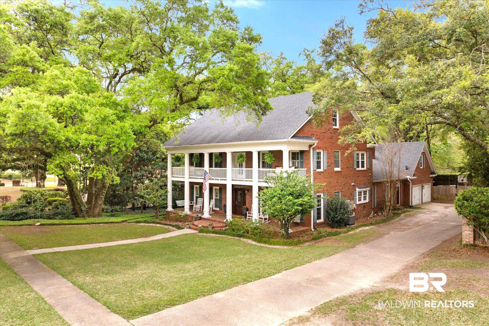 5324 Oak Bend Court Mobile, AL 36609 - Photo 42 of 49 Greek revival house featuring a porch, a garage, brick siding, a front lawn, and driveway