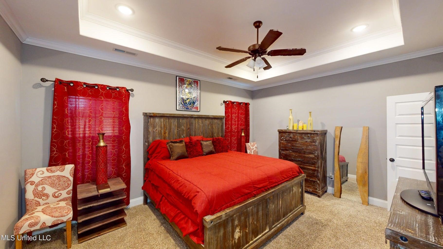 2364 Nikki Ridge Drive Nesbit, MS 38651 - Photo 12 of 26 a bedroom with a bed and a chandelier