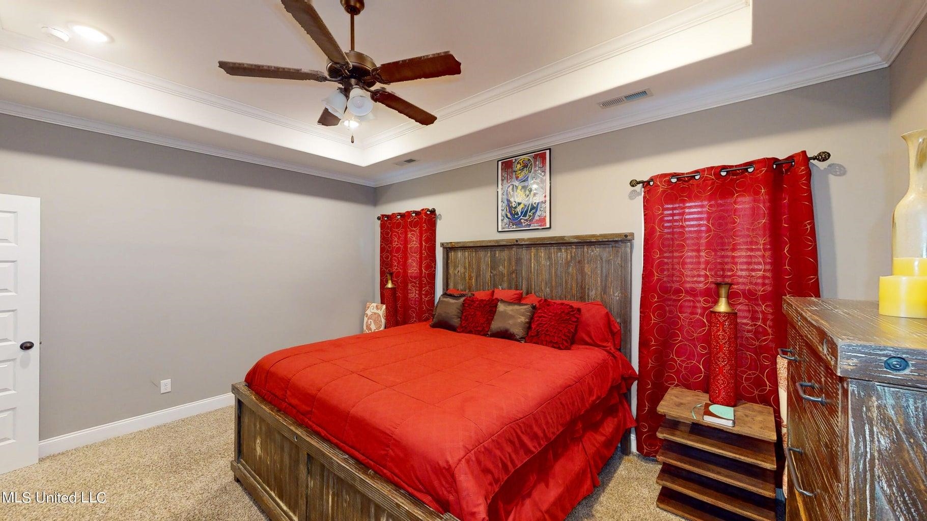 2364 Nikki Ridge Drive Nesbit, MS 38651 - Photo 13 of 26 a bedroom with a bed and a chandelier