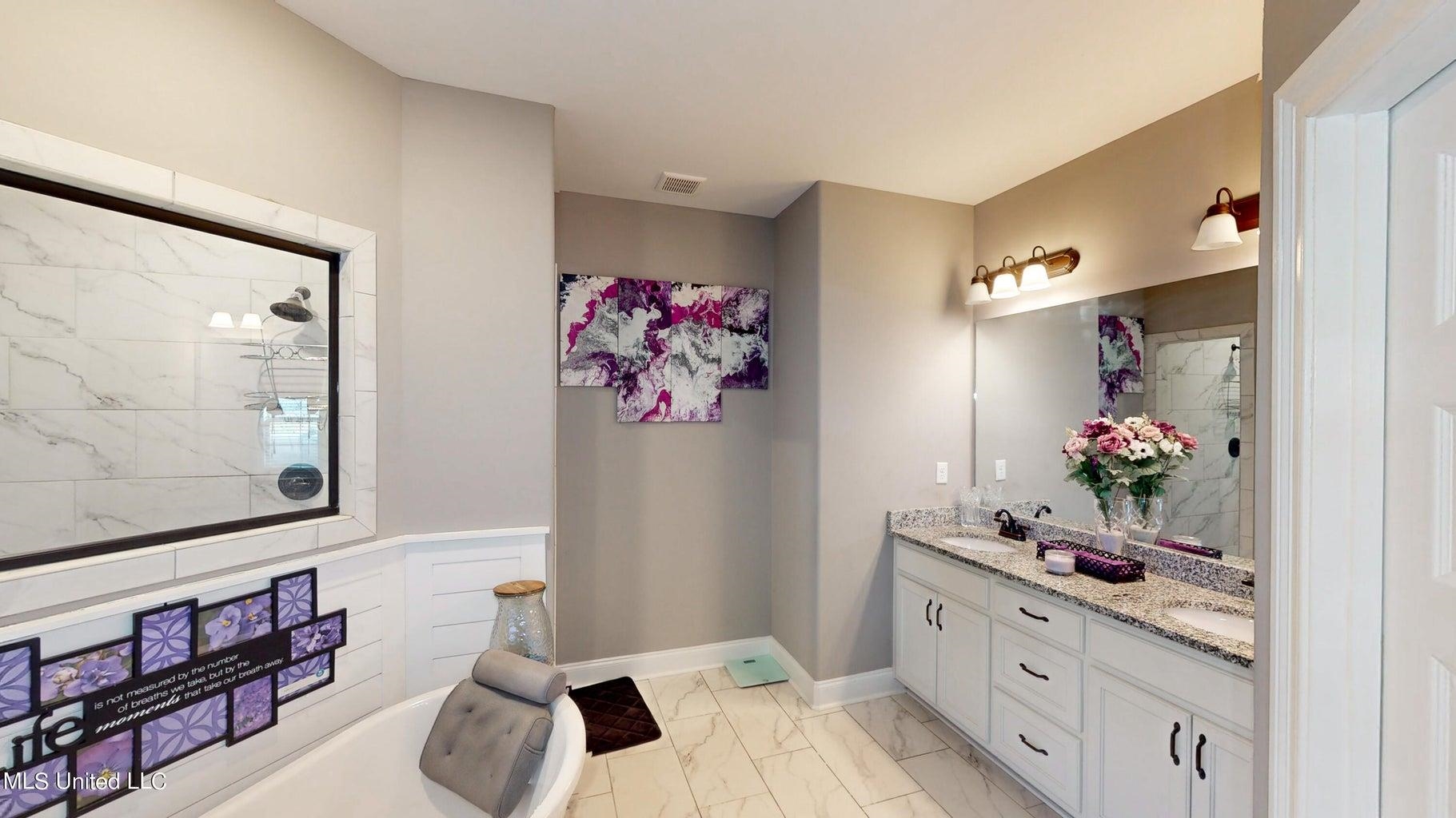 2364 Nikki Ridge Drive Nesbit, MS 38651 - Photo 14 of 26 a bathroom with a sink mirror and vanity