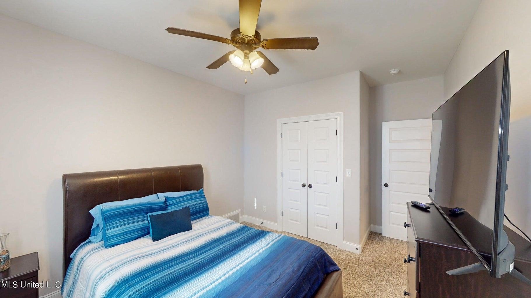 2364 Nikki Ridge Drive Nesbit, MS 38651 - Photo 16 of 26 a bedroom with a bed and a chandelier