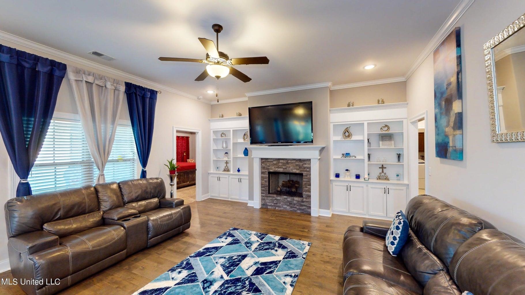 2364 Nikki Ridge Drive Nesbit, MS 38651 - Photo 3 of 26 a living room with furniture a flat screen tv and a fireplace