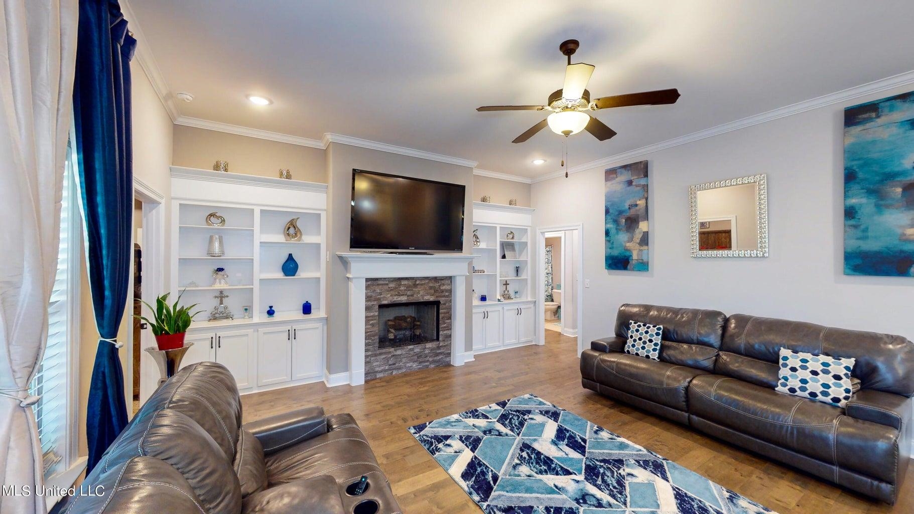 2364 Nikki Ridge Drive Nesbit, MS 38651 - Photo 4 of 26 a living room with furniture a fireplace and a flat screen tv