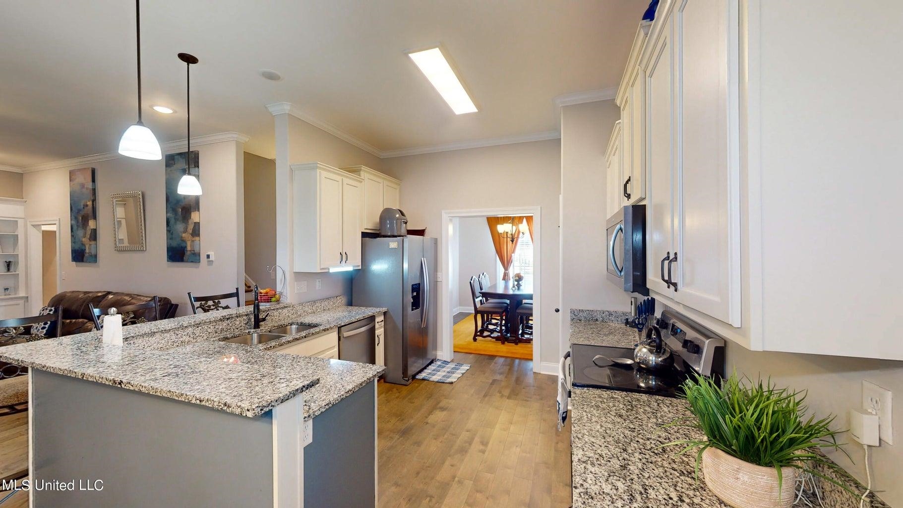 2364 Nikki Ridge Drive Nesbit, MS 38651 - Photo 7 of 26 a kitchen with sink and refrigerator