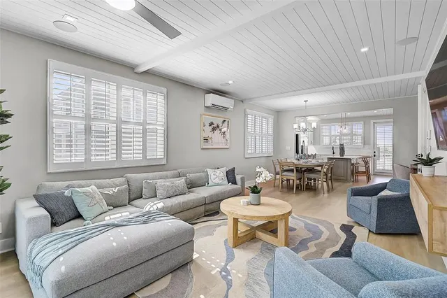 a dining room with glass top table and chairs