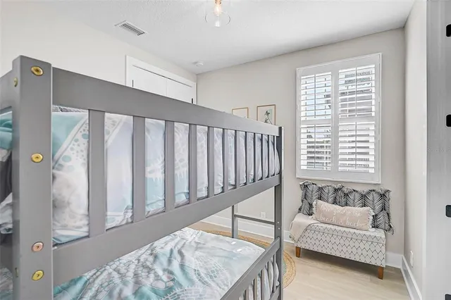 a bed sitting in a bedroom next to a window