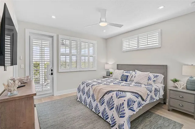 a view of a livingroom with lounge chair and a large window