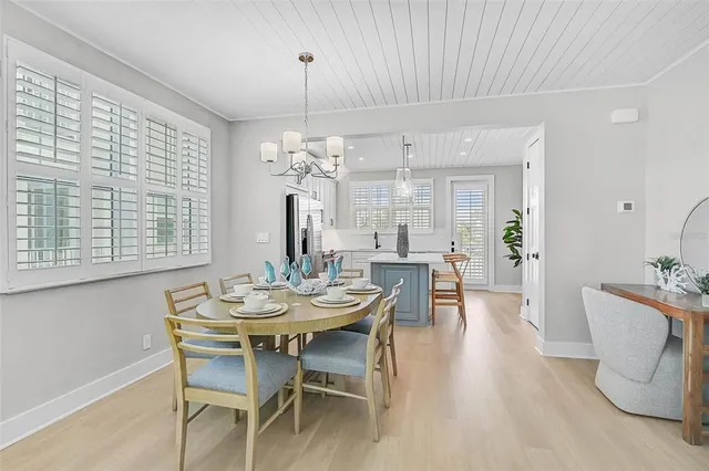 a view of a dining room with furniture and chandelier