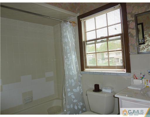 6 Purdue Road Edison, NJ 08820 - Photo 14 of 15 a bathroom with a granite countertop sink and a window